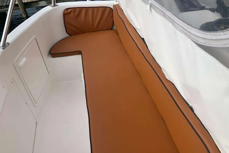 Slide: The Image of 1995 Ocean Yachts 42 Super Sport boat seating area with brown cushions and white interior. - 8
