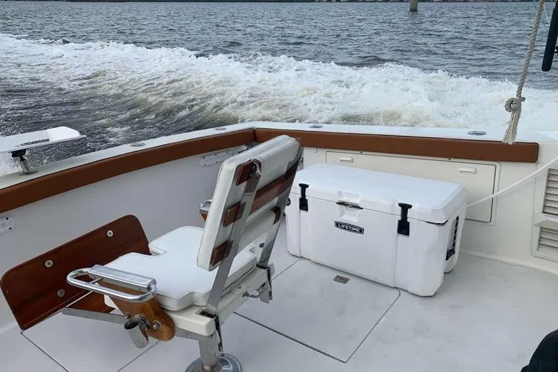Slide: The Image of 1995 Ocean Yachts 42 Super Sport boat deck with chair and cooler on water. - 9