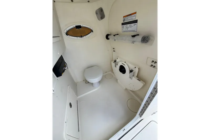 Slide: The Image of 2024 World Cat 295 CC boat interior with toilet and storage area. - 13