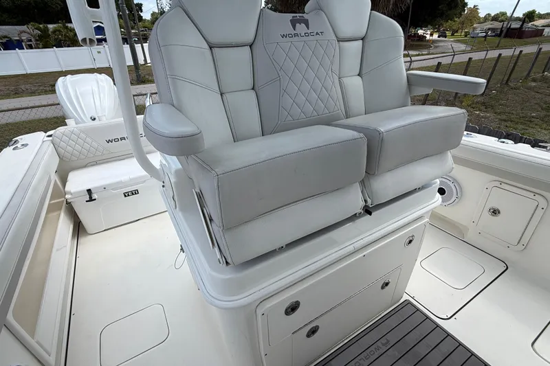 Slide: The Image of 2024 World Cat 295 CC boat interior with plush seating and storage compartments. - 16
