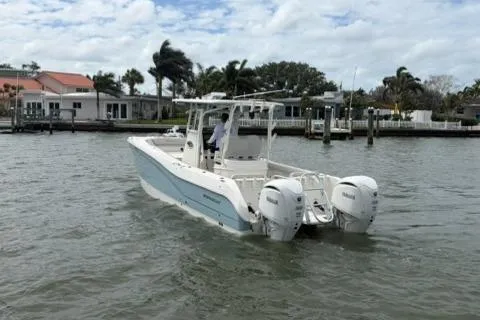 Slide: The Image of 2024 World Cat 295 CC boat on water, featuring dual engines and coastal background. - 4