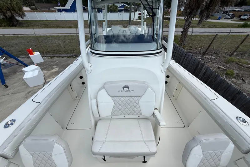 Slide: The Image of 2024 World Cat 295 CC boat interior with white seating and console view. - 8