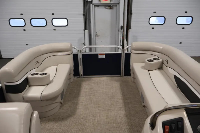 Slide: The Image of 2019 Bennington 20 SL pontoon boat interior with beige seating and cup holders. - 11
