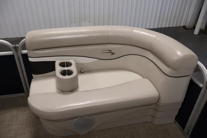 Slide: The Image of 2019 Bennington 20 SL boat seating with cup holders, beige upholstery, and sleek design. - 12