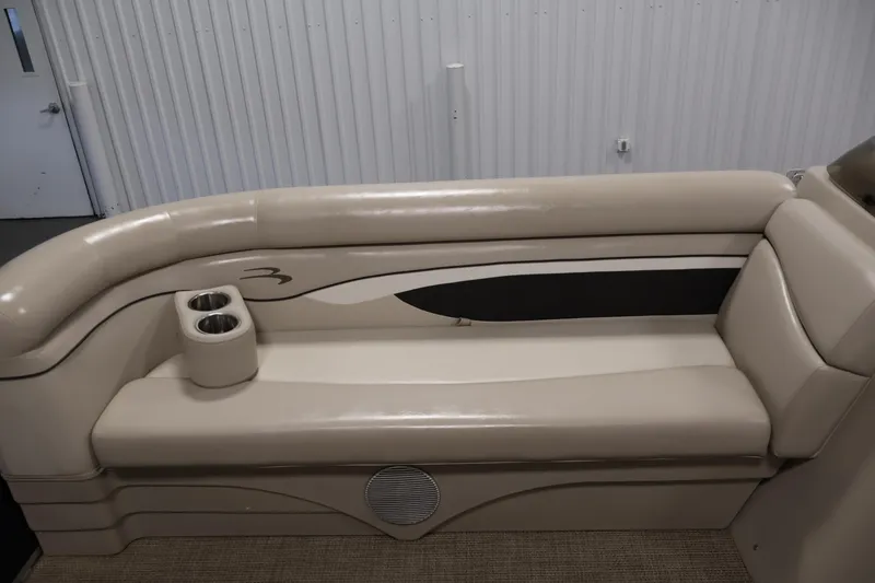 Slide: The Image of 2019 Bennington 20 SL boat interior with beige seating and cup holders. - 15