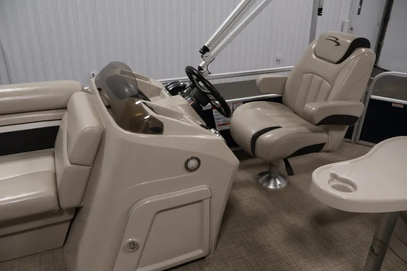Slide: The Image of Interior of a 2019 Bennington 20 SL boat with beige seating and steering console. - 18