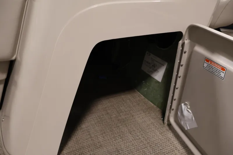 Slide: The Image of 2019 Bennington 20 SL boat storage compartment with open hatch and warning label. - 19