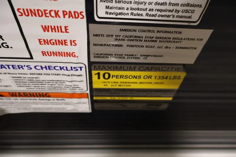 Slide: The Image of Safety and capacity labels on a 2019 Bennington 20 SL pontoon boat. - 26
