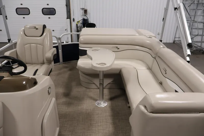 Slide: The Image of 2019 Bennington 20 SL pontoon boat interior with beige seating and steering console. - 28