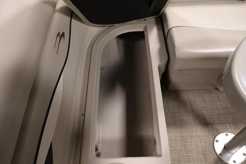 Slide: The Image of Storage compartment in a 2019 Bennington 20 SL boat, featuring beige interior and carpeted flooring. - 30