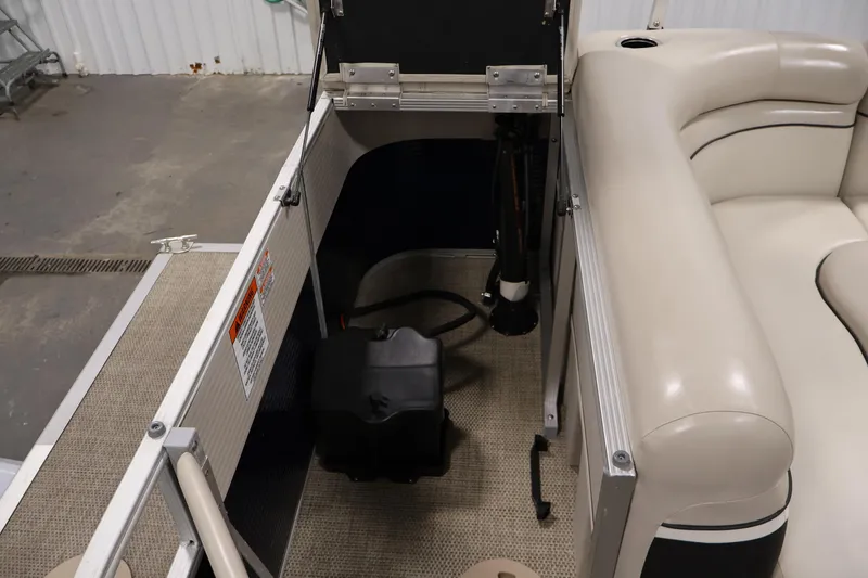 Slide: The Image of 2019 Bennington 20 SL pontoon boat interior with beige seating and storage compartment. - 32