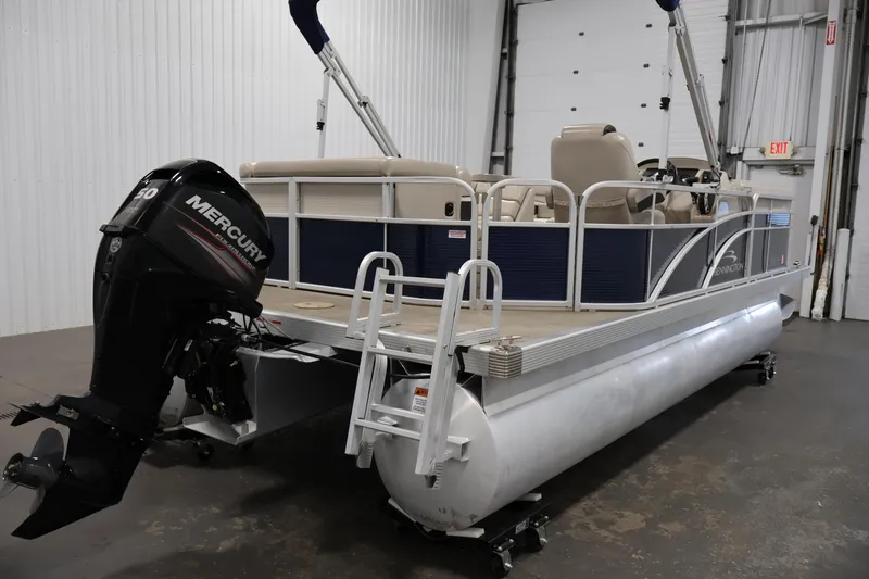 Slide: The Image of 2019 Bennington 20 SL pontoon boat with Mercury engine in a warehouse setting. - 5