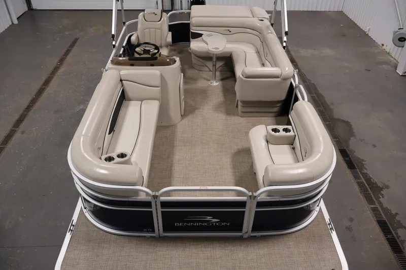 Slide: The Image of 2019 Bennington 20 SL pontoon boat with beige seating and spacious layout. - 9