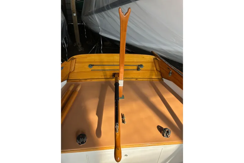 Slide: The Image of Wooden tiller of a 1982 Herreshoff 12.5 footer sailboat, showcasing classic craftsmanship. - 10