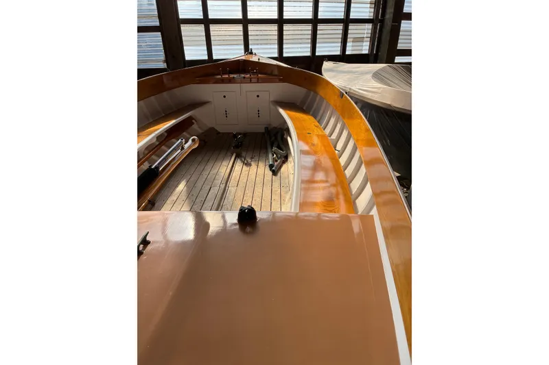 Slide: The Image of 1982 Herreshoff 12.5 footer sailboat interior with wooden deck and polished finish. - 17