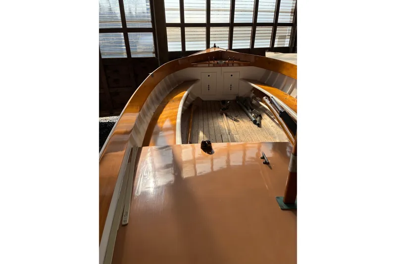 Slide: The Image of Interior view of a 1982 Herreshoff 12.5 footer sailboat, showcasing wooden craftsmanship. - 18