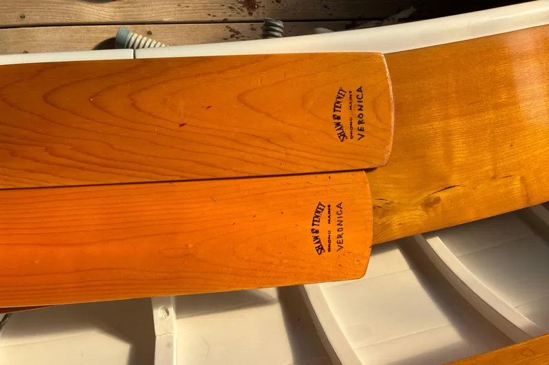 Slide: The Image of Wooden oars on a Herreshoff 12.5 footer, 1982 model, with "VERONICA" branding. - 23