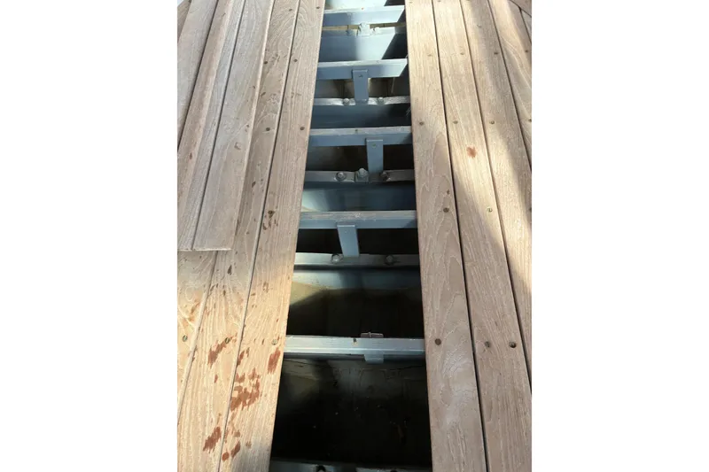 Slide: The Image of Wooden deck of a 1982 Herreshoff 12.5 footer sailboat, showing structural beams. - 27
