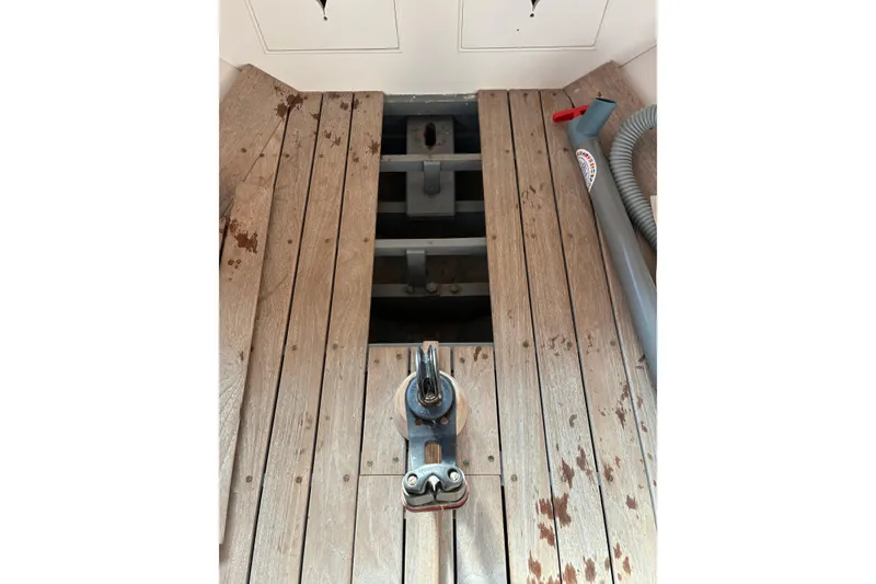 Slide: The Image of Wooden deck of a 1982 Herreshoff 12.5 footer sailboat with visible fittings. - 28