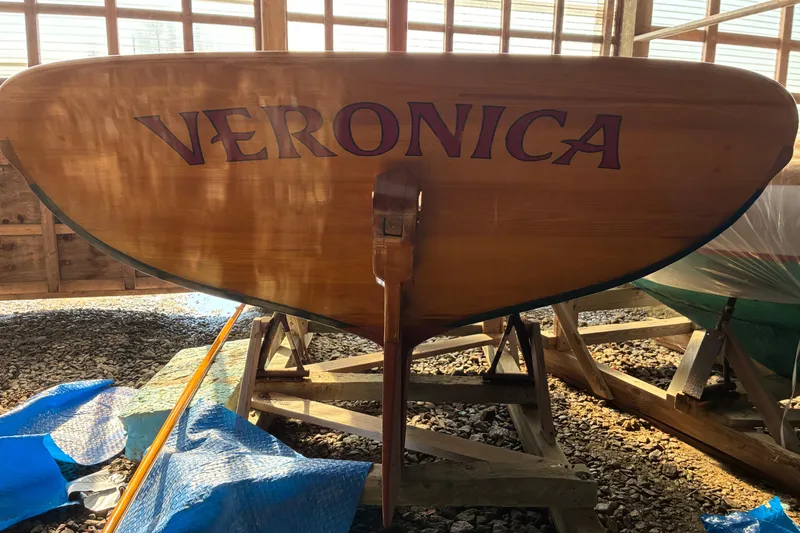 Slide: The Image of 1982 Herreshoff 12.5 footer sailboat named "Veronica" in a wooden boathouse. - 3