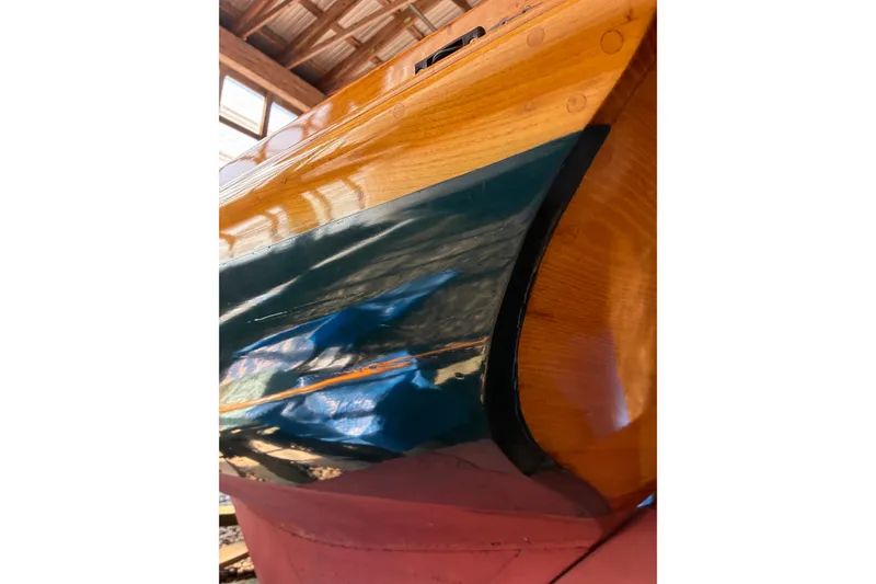 Slide: The Image of Close-up of a 1982 Herreshoff 12.5 footer boat hull in a workshop. - 37