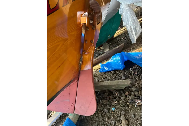 Slide: The Image of Close-up of a 1982 Herreshoff 12.5 footer rudder, showcasing wooden craftsmanship. - 38
