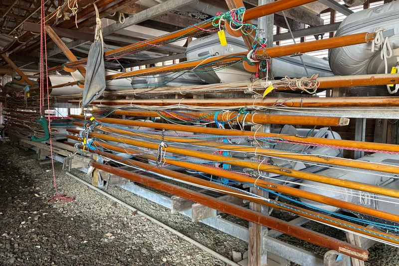 Slide: The Image of Wooden masts and rigging stored in a shed, Herreshoff 12.5 footer, 1982 model. - 39