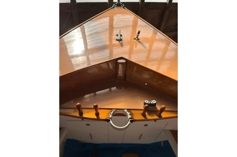 Slide: The Image of 1982 Herreshoff 12.5 footer boat deck with polished wood finish. - 4
