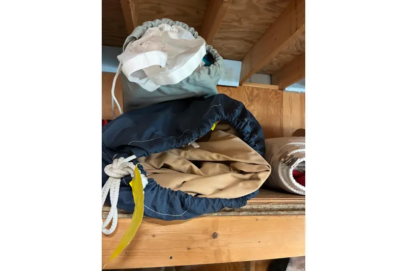 Slide: The Image of Sailboat equipment stored on wooden shelf, related to 1982 Herreshoff 12.5 footer. - 40