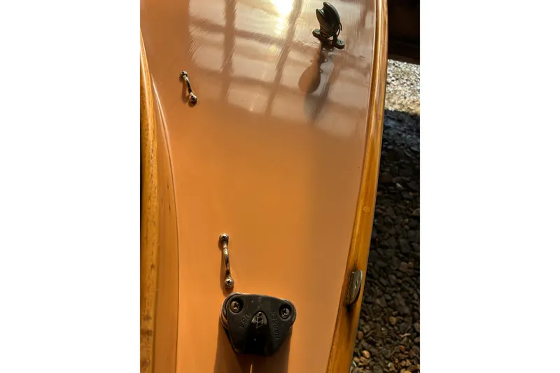 Slide: The Image of Close-up of a 1982 Herreshoff 12.5 footer boat deck with hardware details. - 6