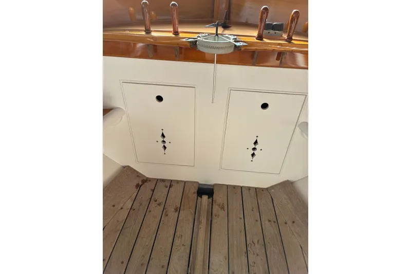 Slide: The Image of Interior view of a 1982 Herreshoff 12.5 footer sailboat with wooden flooring. - 7