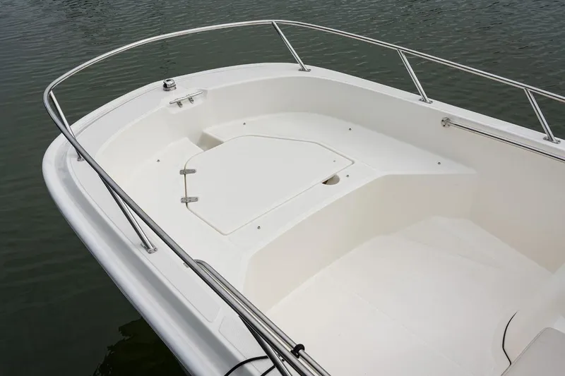 Slide: The Image of Manufacturer Provided Image: 2026 Boston Whaler 160 Super Sport boat deck with railing on calm water. - 6
