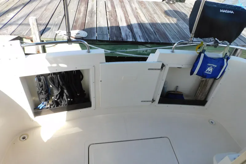 Slide: The Image of 2000 Camano Troll boat deck with storage compartments and accessories. - 11