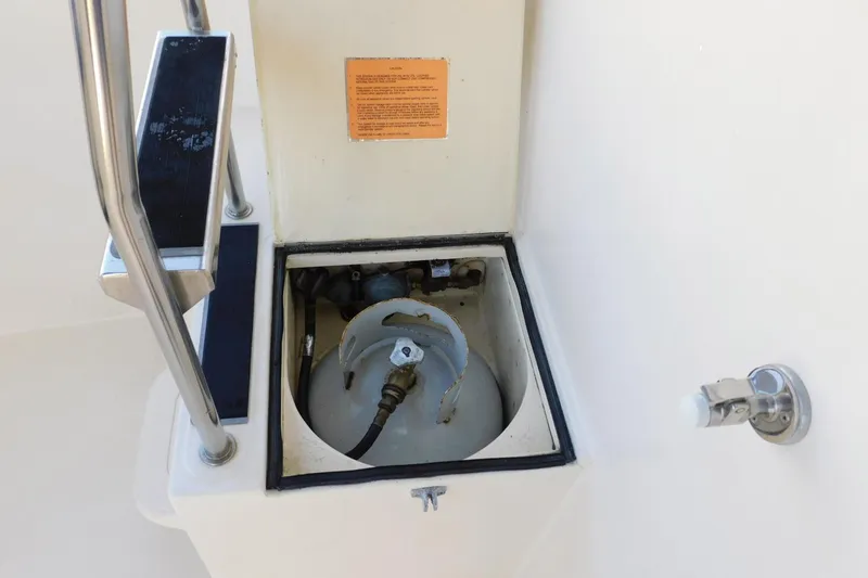 Slide: The Image of Compartment on 2000 Camano Troll boat with propane tank and metal railing. - 12