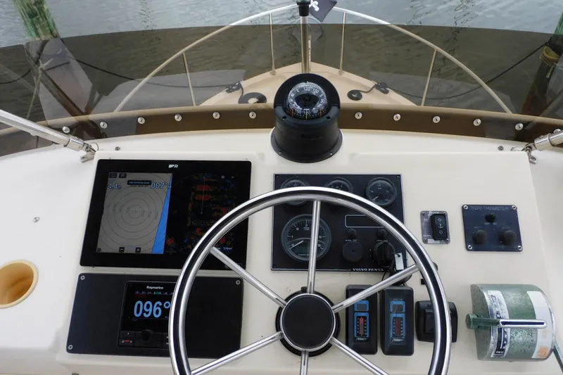Slide: The Image of Helm of 2000 Camano Troll boat with navigation instruments and steering wheel. - 14