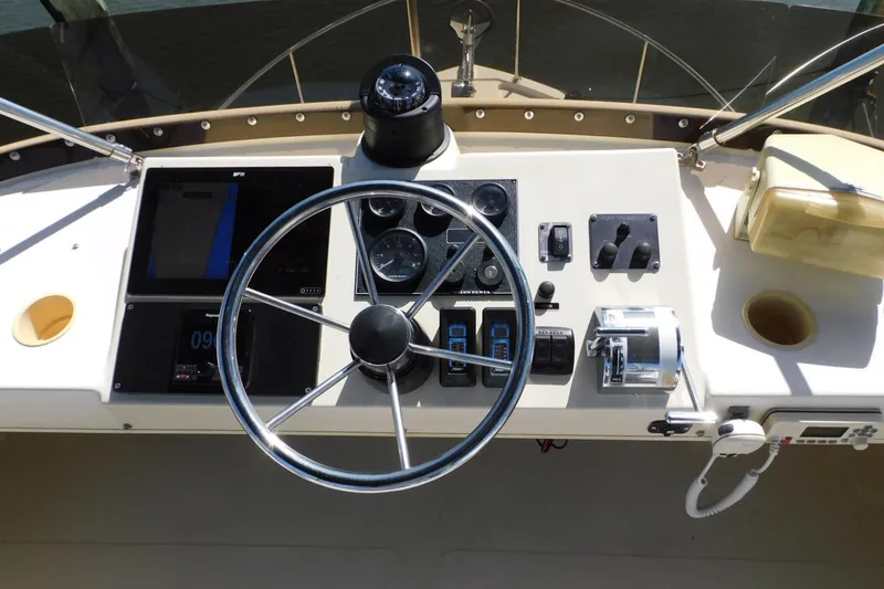 Slide: The Image of Helm of 2000 Camano Troll boat with steering wheel and navigation controls. - 15