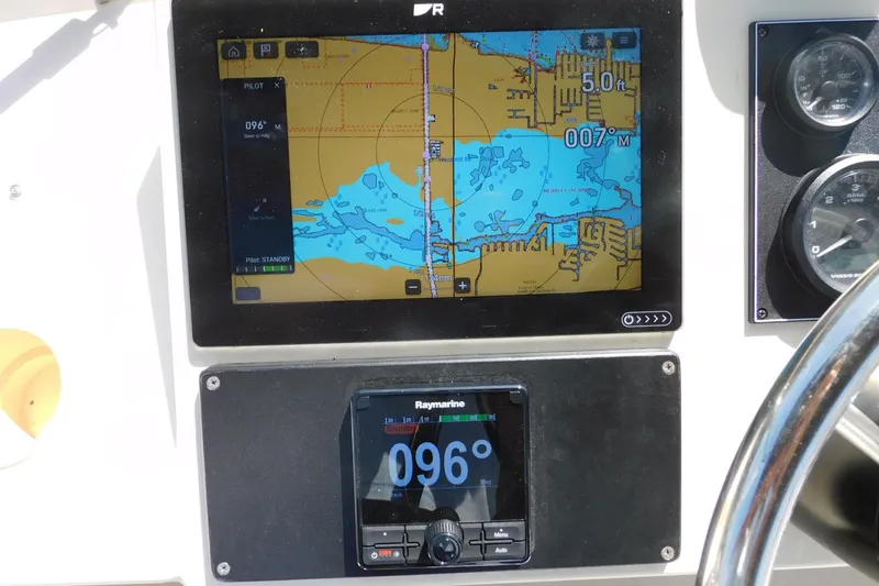 Slide: The Image of Navigation system on a 2000 Camano Troll boat displaying nautical charts and heading. - 17