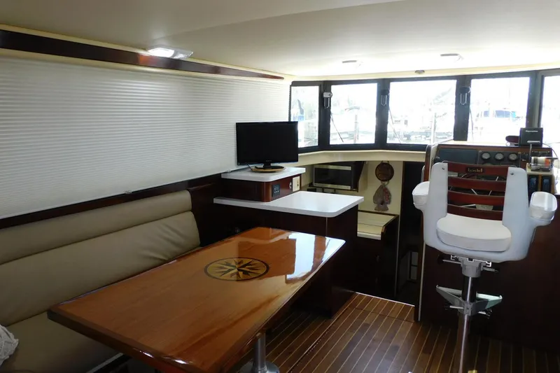 Slide: The Image of Interior of 2000 Camano Troll boat with seating, table, and helm station. - 18