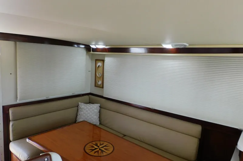 Slide: The Image of Interior of 2000 Camano Troll boat with cozy seating and wooden table. - 20
