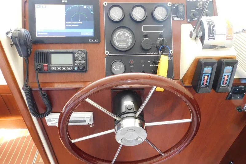Slide: The Image of Steering wheel and control panel of a 2000 Camano Troll boat. - 22