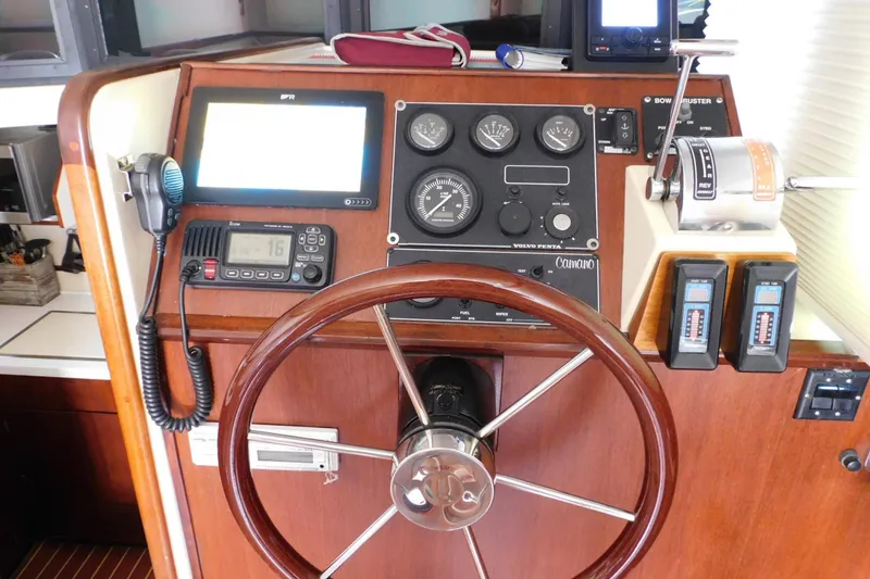 Slide: The Image of Control panel of a 2000 Camano Troll boat with steering wheel and navigation instruments. - 25