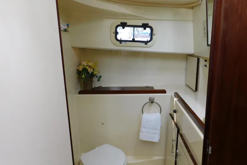 Slide: The Image of Bathroom interior of 2000 Camano Troll boat with window and floral decor. - 27
