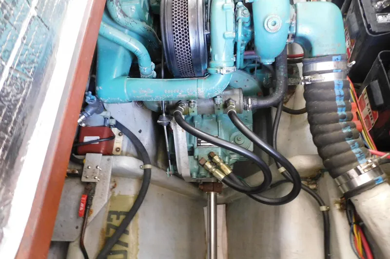 Slide: The Image of Engine compartment of a 2000 Camano Troll boat, showcasing mechanical components and hoses. - 33