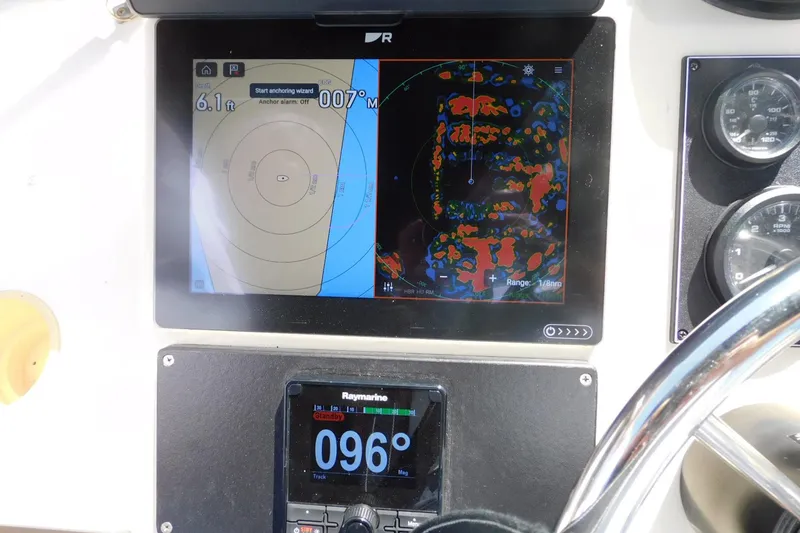 Slide: The Image of Navigation system on a 2000 Camano Troll boat dashboard, displaying radar and GPS data. - 37
