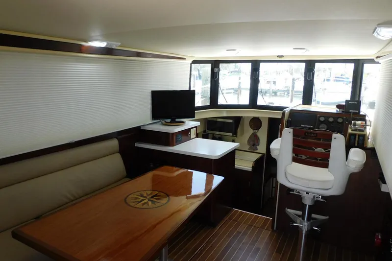 Slide: The Image of Interior of 2000 Camano Troll boat with seating, table, and helm station. - 39