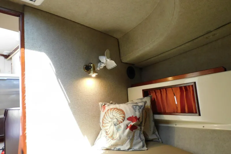 Slide: The Image of Cozy interior of 2000 Camano Troll boat with decorative pillows and wall light. - 40