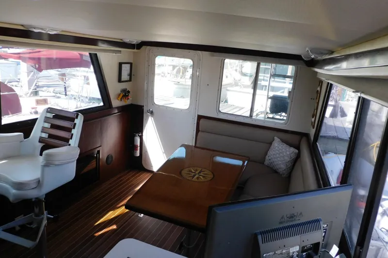 Slide: The Image of Interior of a 2000 Camano Troll boat with seating and helm station. - 48