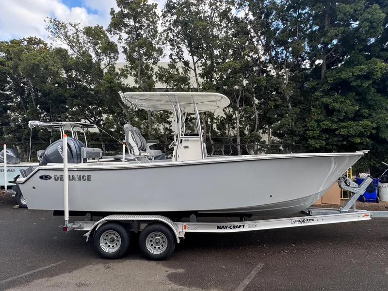 The Image of 2025 Defiance Catalina 240 boat on trailer, parked outdoors, surrounded by trees. - 0