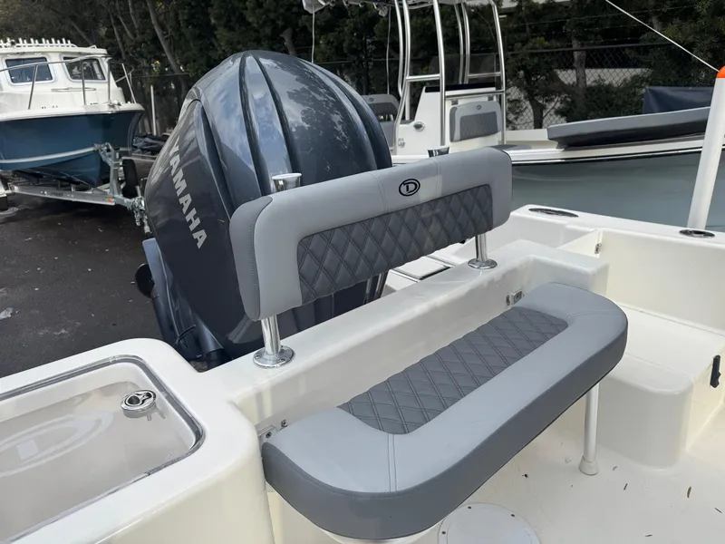 Slide: The Image of 2025 Defiance Catalina 240 boat with Yamaha engine and cushioned seating. - 12
