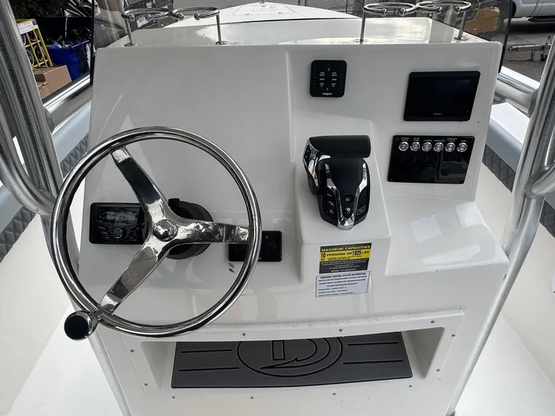Slide: The Image of 2025 Defiance Catalina 240 boat dashboard with steering wheel and controls. - 21